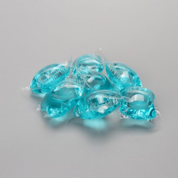 Blue laundry detergent capsules