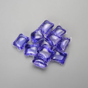 Purple laundry detergent capsules